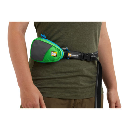 Shown waist-worn, the Ruffwear Stash Bag™ pick-up bag / poo bag storage and dispensing system. Meadow Green.